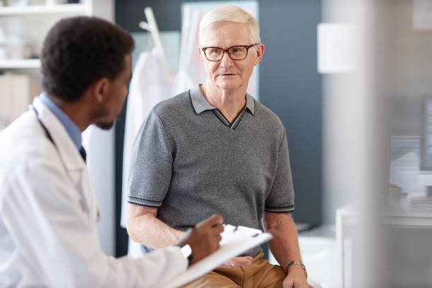 istock Senior Man Talking to Doctor in Consultation Explaining Symptoms Health Concerns 2190554549