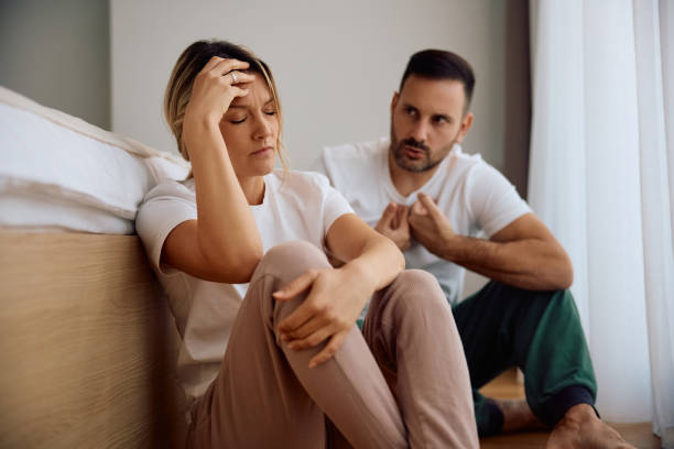 Displeased couple discussing about their relationship problems at home.