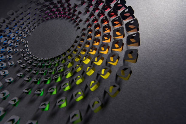 istock Cut paper artwork featuring colorful arrow icons in a circular pattern on a dark textured background 2190557841