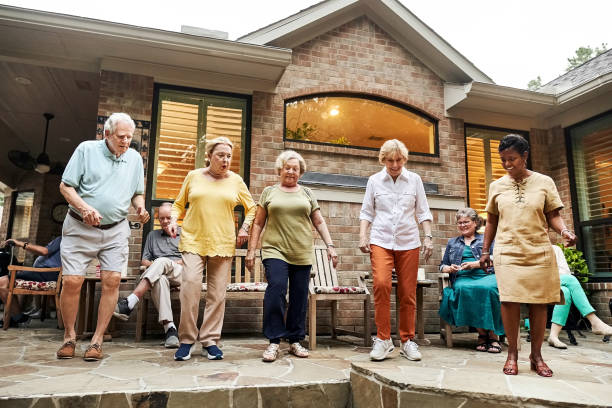 istock Senior friends enjoying dance together in home backyard 2190557867