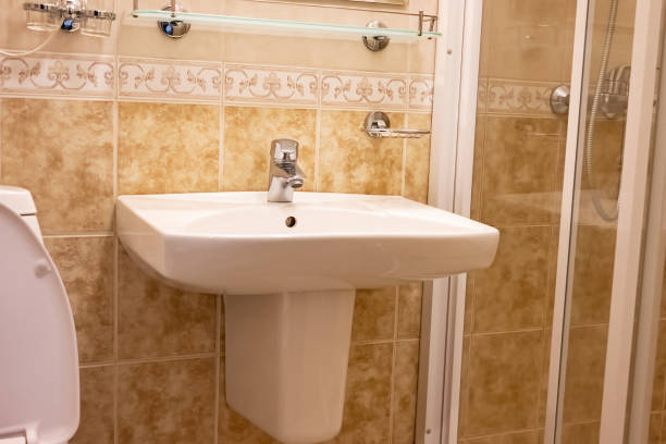 istock Bathroom sink with chrome faucet and soap dish on tiled wall. 2190558593