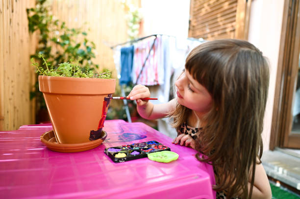istock Little girl playing with paints 2190559552