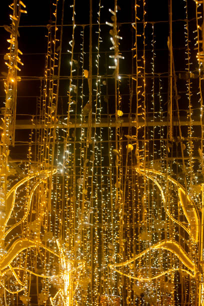 istock City street Christmas decorations. Rows of multi colored LED  light spots . 2190561193