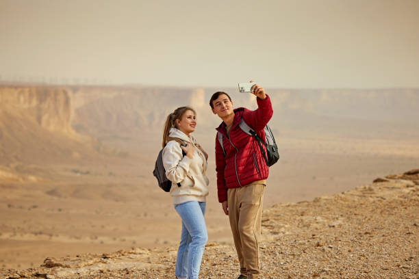 istock Couple capturing selfie with stunning desert escarpment view 2190561280
