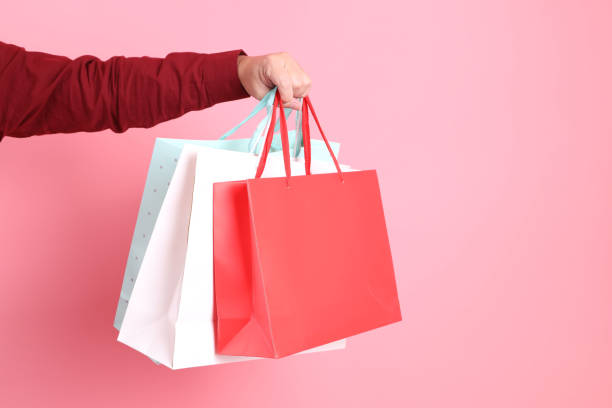 istock hand holding shopping bag 2190562125