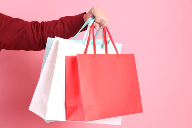 istock hand holding shopping bag 2190562153