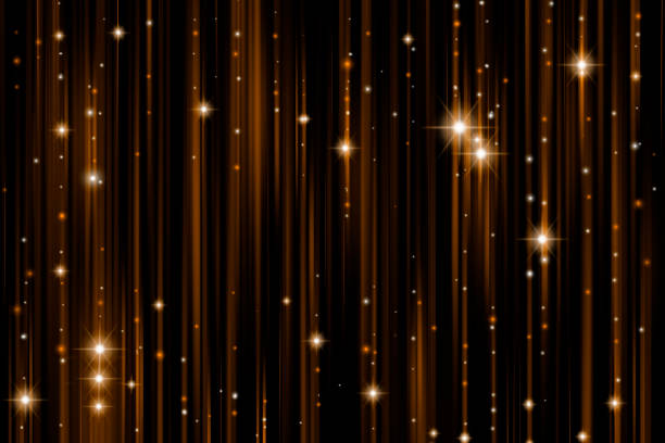 Golden glittering threads on black background.