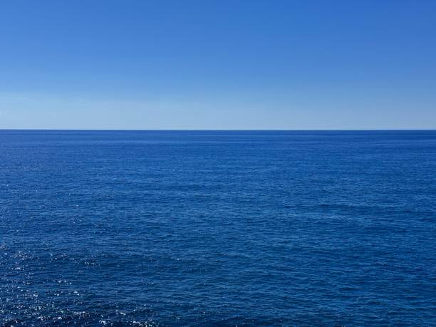 istock Open sea blue calm water and cloudless sky. 2190568015