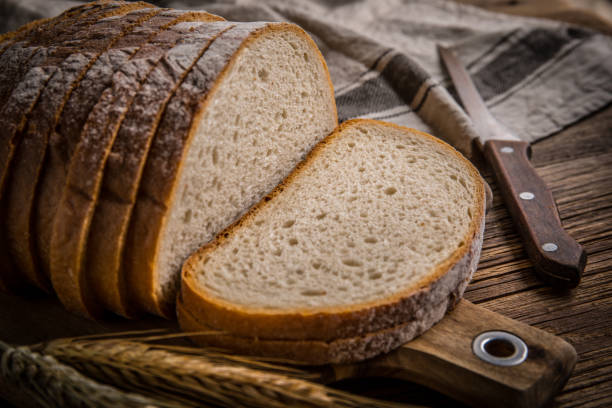 istock Sliced loaf of bread on a chopping board. 2190569009