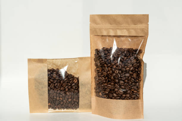 istock A kraft paper bag with coffee beans for viewing with a highlighted shadow lies on a white background 2190569120