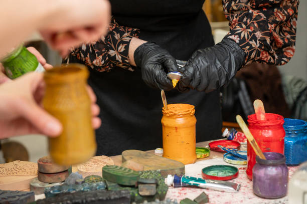 istock Artistic workshop with female hands creating colorful craft prints 2190569125