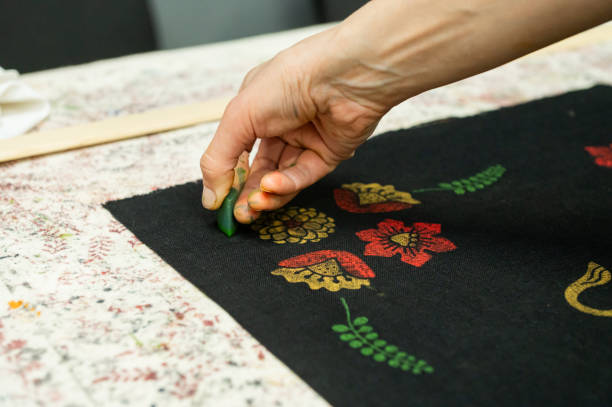 Hand block printing on fabric with bright floral patterns