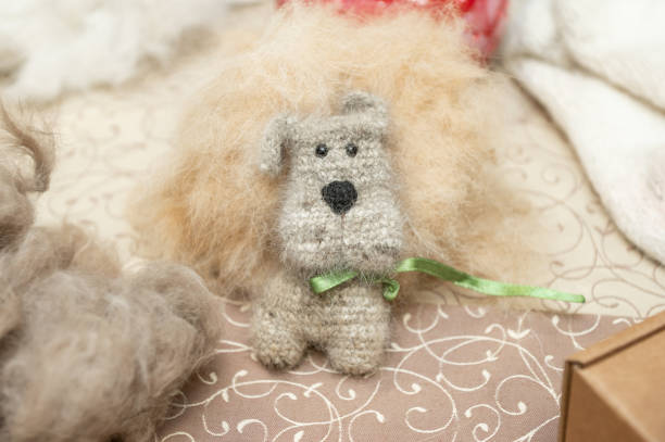 istock Handmade felted dog toy with green ribbon on patterned fabric surface 2190569167