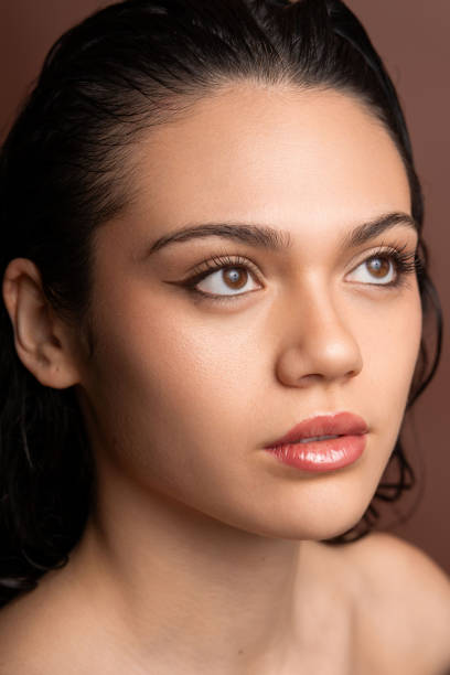 istock Wet-haired latina model displaying dramatic makeup, gazing sideways with sultry expression 2190569960