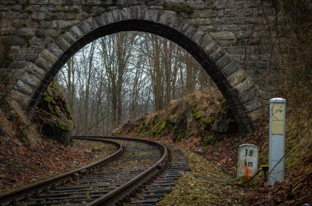 Old stone road bridge over railway in autumn day near Malenice stop CZ 12 12 2024