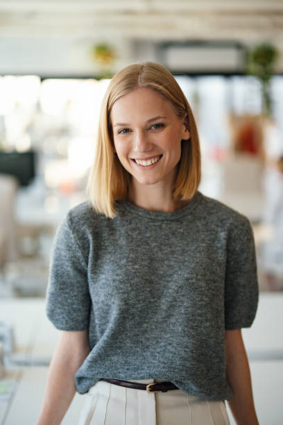 istock Professional Smiling Woman in Modern Work Environment with Natural Lighting 2190572358