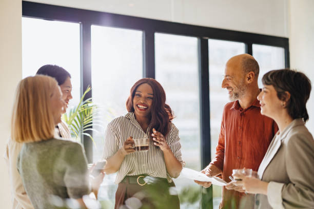 Diverse Team Engages in a Friendly Business Discussion in Modern Office Setting