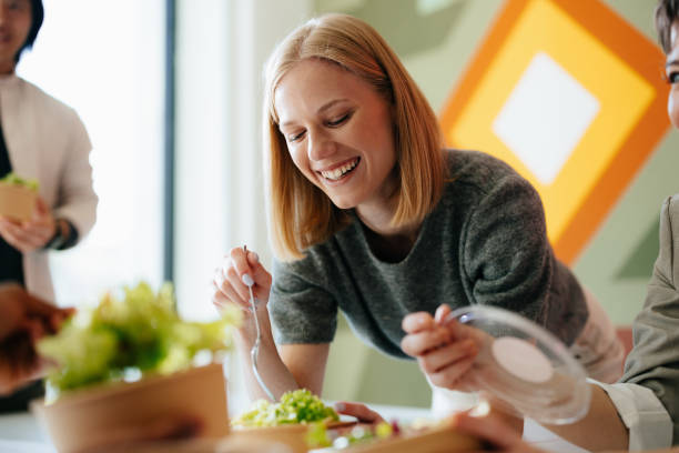 Group Enjoying Healthy Lunch Together at Workplace in Modern Office Setting