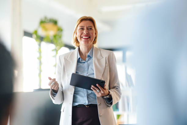 istock Confident Professional Woman Leading a Business Presentation in a Modern Office Setting 2190572406