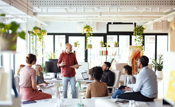 Team Collaboration in a Modern Office Co-Working Space with Plants