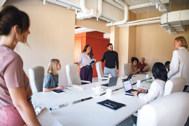 istock Group of Professionals Collaborating in a Modern Office Workspace 2190572415