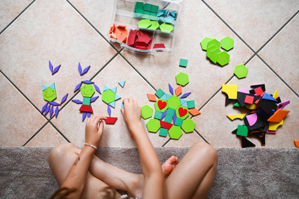 istock Girl playing with tangram. 2190576084