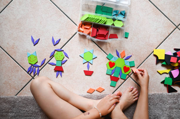 istock Unrecognizable girl playing with tangram puzzle 2190576115