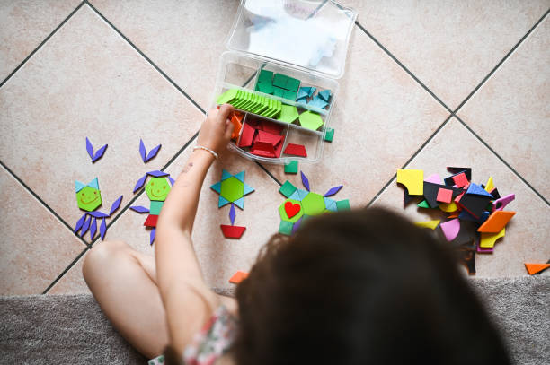 istock girl playing with tangram puzzle 2190576133