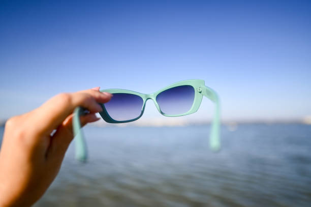 istock Woman holding modern sunglasses. 2190577335
