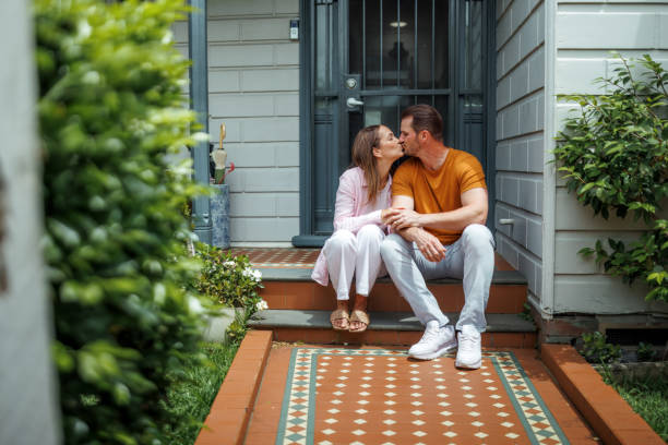istock Young couple bonding in front of their house 2190577425