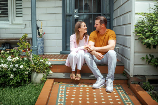 istock Young couple bonding in front of their house 2190577433