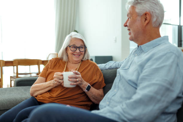 istock Senior couple relaxing on a sofa at home 2190577517