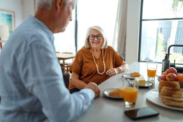 istock Senior couple having breakfast together at home 2190577819