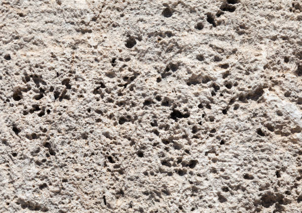 High-resolution abstract textures of natural stone, concrete, and mineral surfaces featuring porous, rough, cracked, and weathered patterns. Organic backgrounds with irregular holes, bubbles, erosion marks, and layered structures. Suitable for use in graphic design, architecture, interior design, branding, packaging, posters, web backgrounds, and creative compositions. Ideal as natural, raw, and industrial texture backdrops.