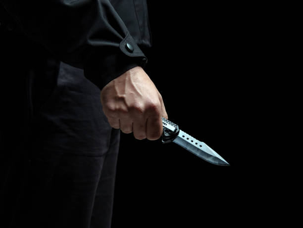 istock Criminal holding a knife closeup, armed attack concept. 2190582533