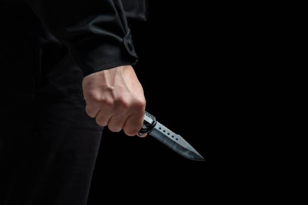 istock Criminal holding a knife closeup, armed attack concept. 2190582560