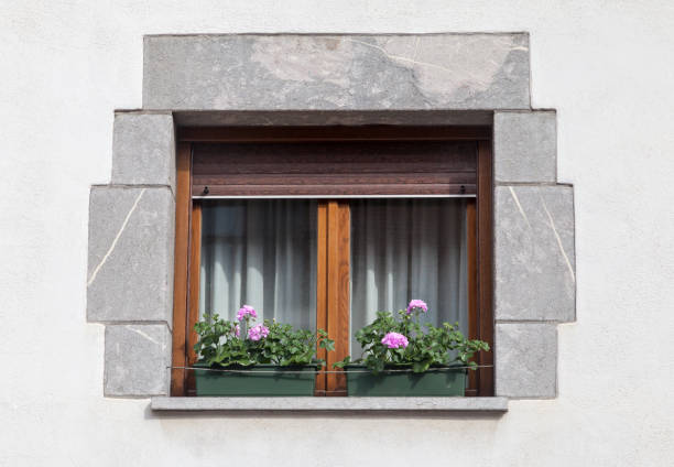 istock Charming wooden window with flower box in a rustic building during daylight 2190584059