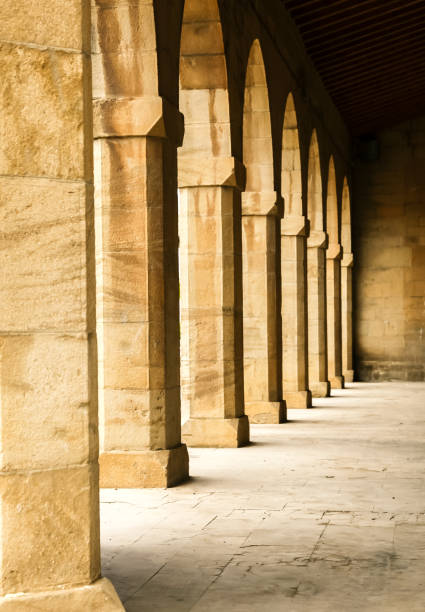 istock Elegant stone arches create a serene walkway in an ancient building under soft morning light 2190584066