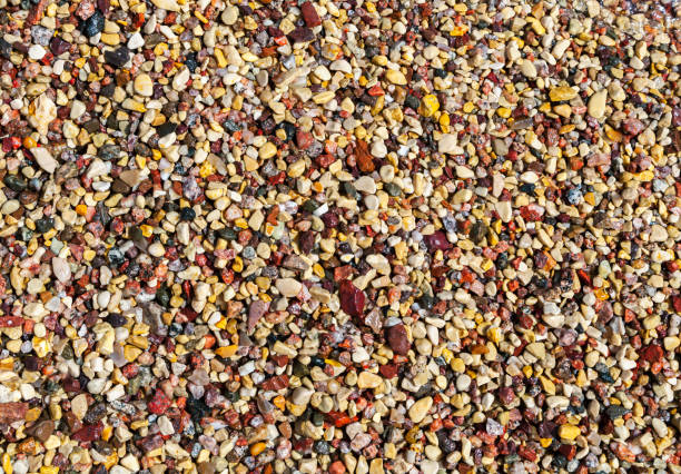 Wet colorful pebbles on a sea shore, natural background