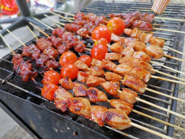 Satay is grilled on a barbecue grill