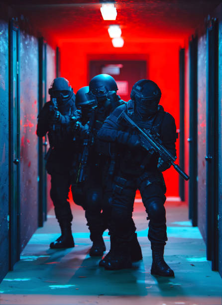 istock SWAT Raid Scene with Officers Moving Through a Red and Blue Lit Corridor 2190588709