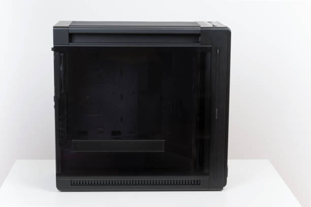 istock Side view of empty big tower, PC case, chassis,  tempered-glass left panel has a mesh window to aid in graphics-card ventilation 2190589354