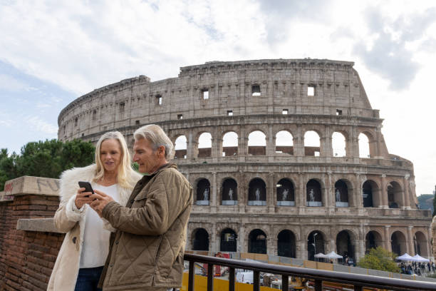 istock Mature tourist couple use mobile phone at viewpoint 2190597470
