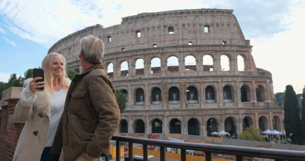 istock Mature tourist couple use mobile phone at viewpoint 2190597511