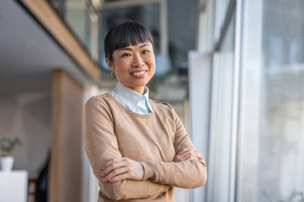 istock Confident Asian professional staring at camera with arms crossed 2190600433