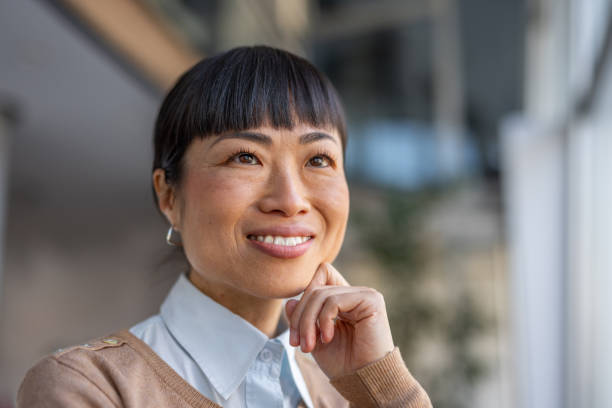 istock Smiling Japanese woman in a workspace 2190600456