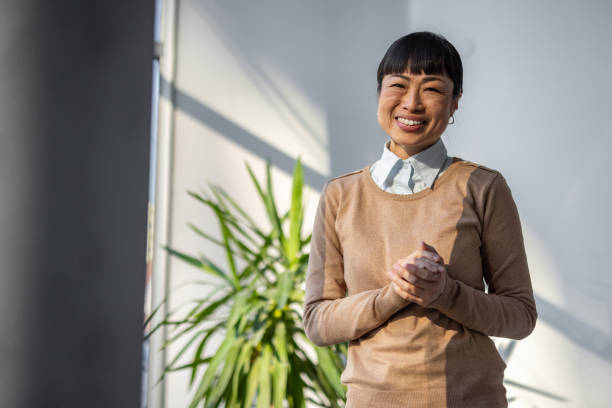istock Smiling Japanese woman in a workspace 2190600512