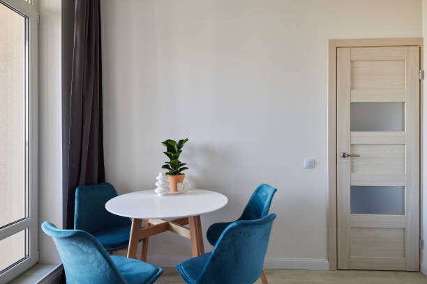 istock A Contemporary Cozy Dining Space Featuring a Round Table Surrounded by Stylish Blue Chairs 2190600884