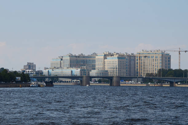A contemporary urban skyline with buildings overlooking a river, showcasing a dynamic city environment.