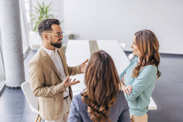 istock Three business colleagues talking about paperwork at the office 2190602734